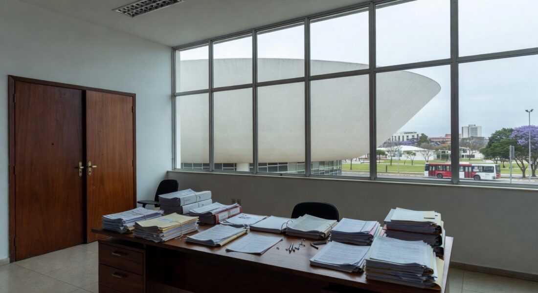 Edifício governamental em Brasília com formulários de inscrição, relógio e barreiras simbólicas para conselho da Caesb e Adasa.